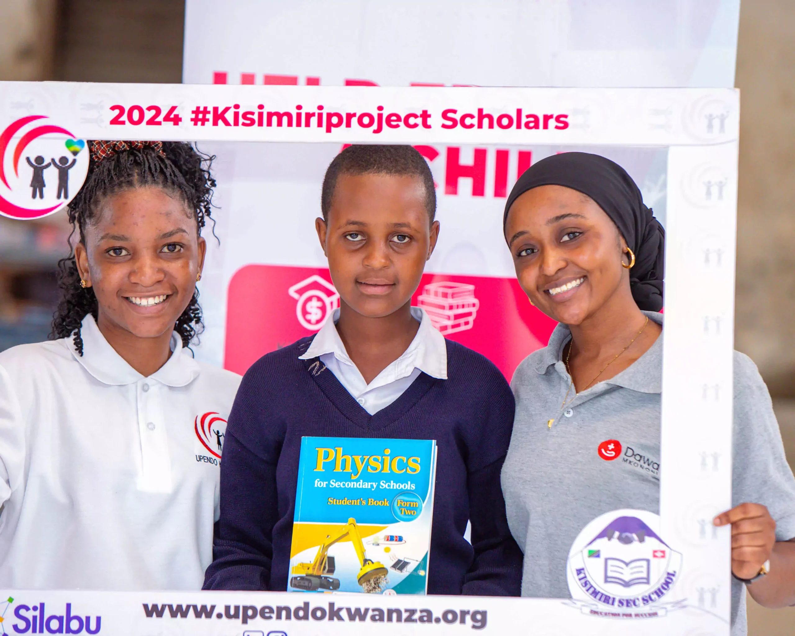 little school girls smiling while holding their new textbooks