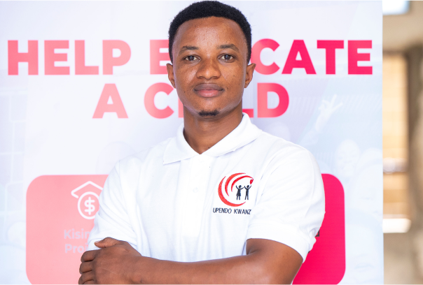 A headshot of Gerald Daud wearing white t-shirt with Upendo kwanza logo