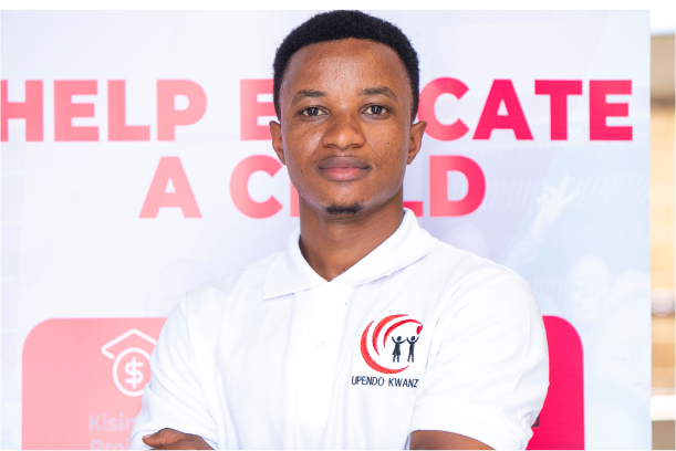 A headshot of Gerald Daud wearing white t-shirt with Upendo kwanza logo