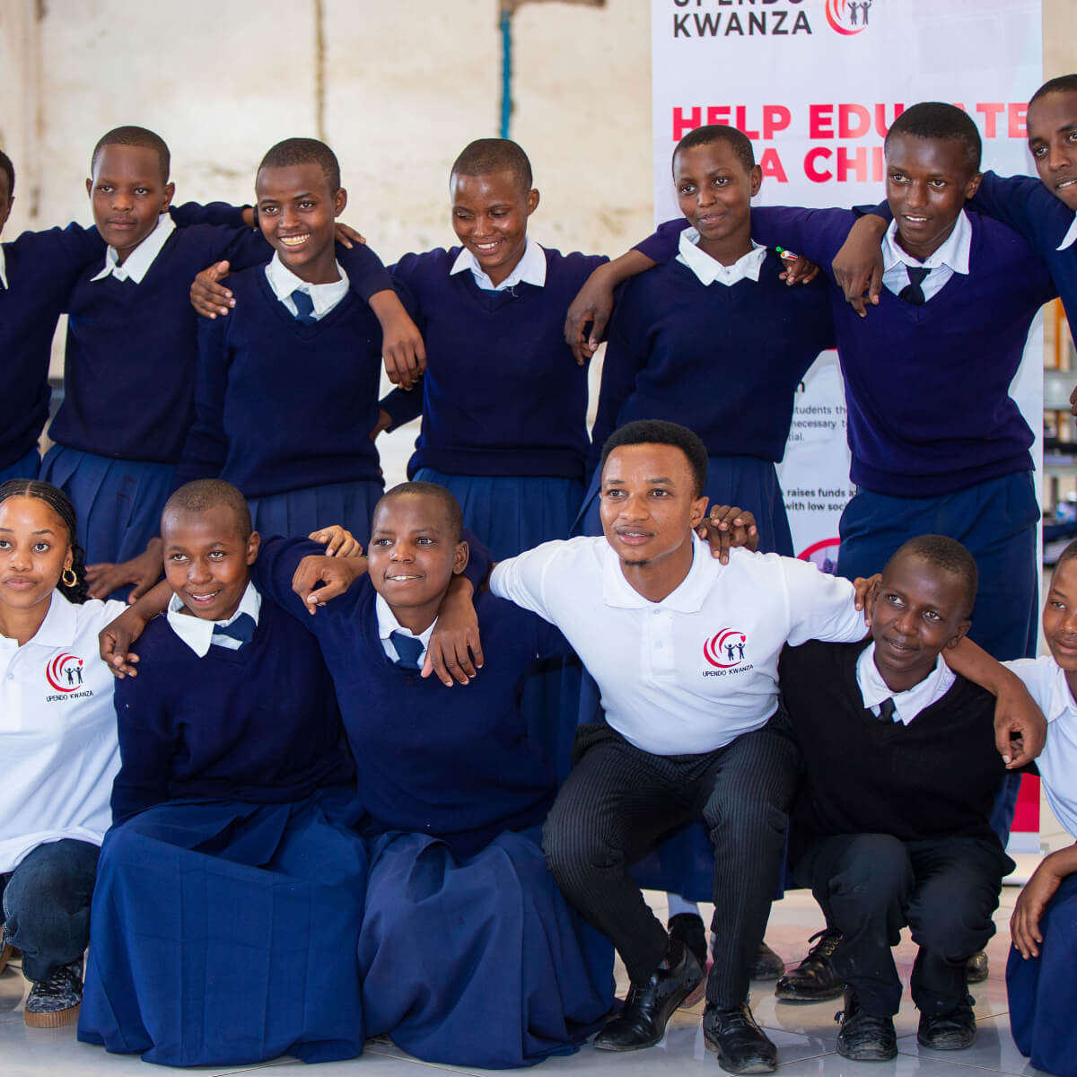 Students sit on the school ground for a